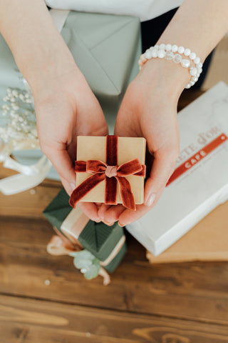 Youthful hands holding Small Gift